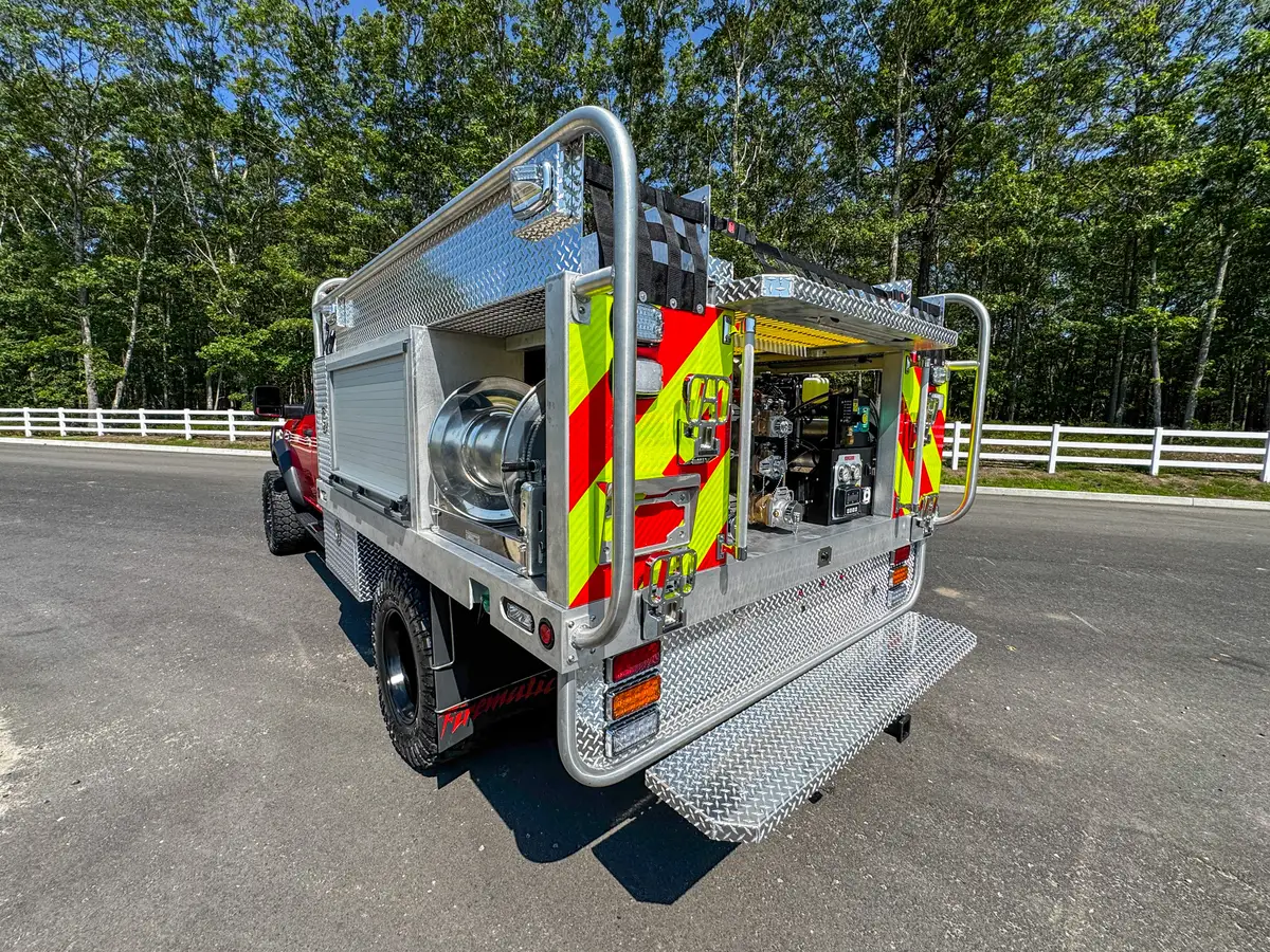 Rear-left corner close-up showing chevron striping, taillight, and side marker.
